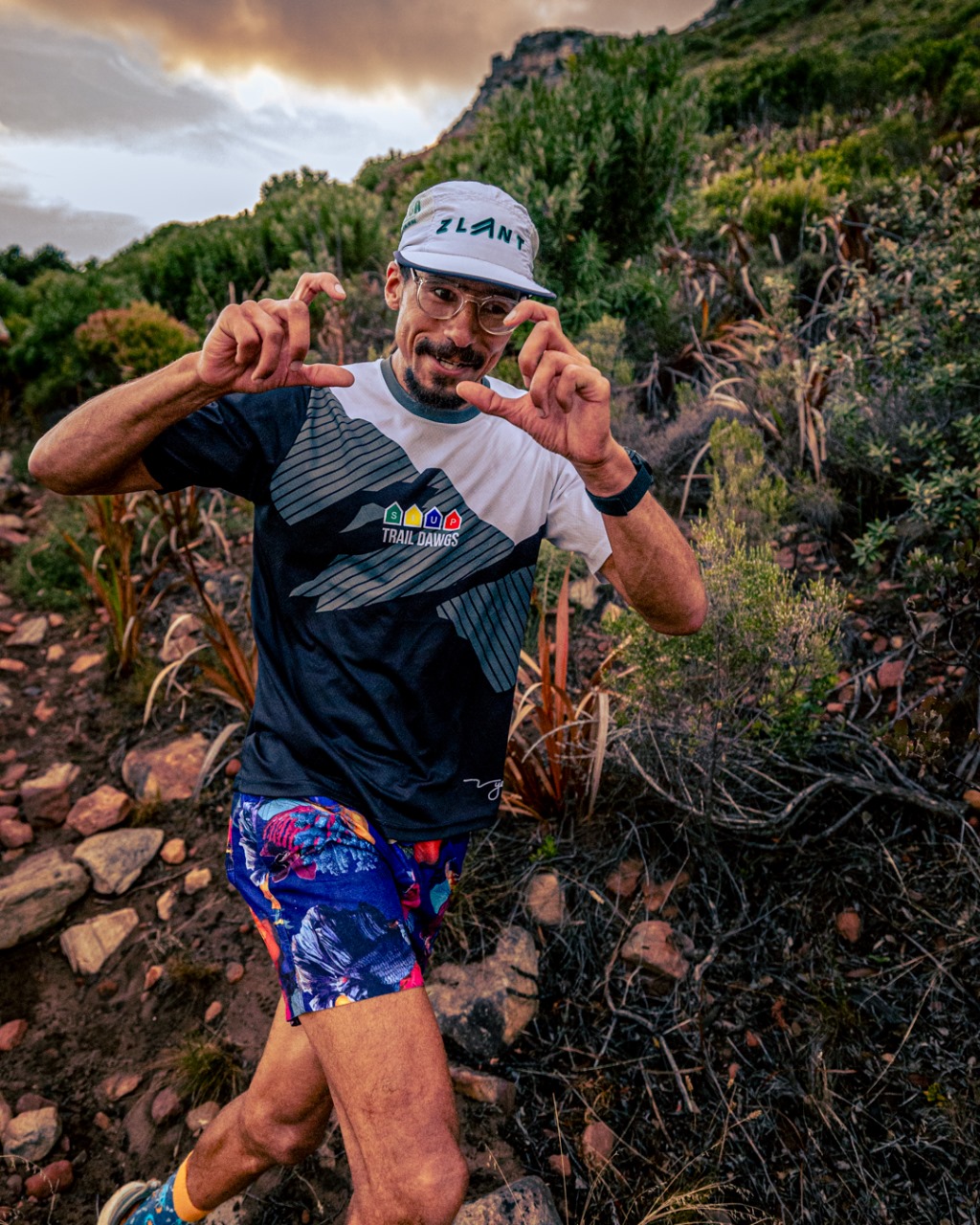 Runner wearing TrailDawgs gear making playful gestures showing fun personality
